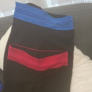2 pairs of Black yoga pants with Blue and Red Waistbands